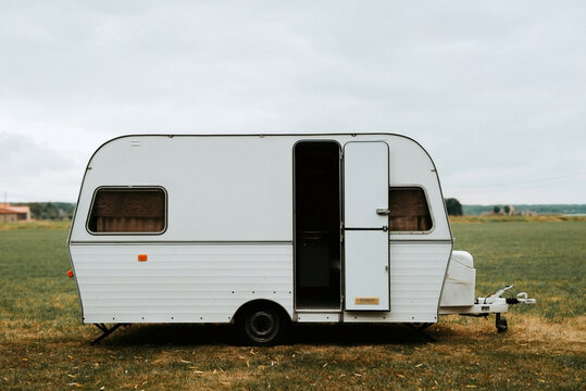 White caravan on a grass field