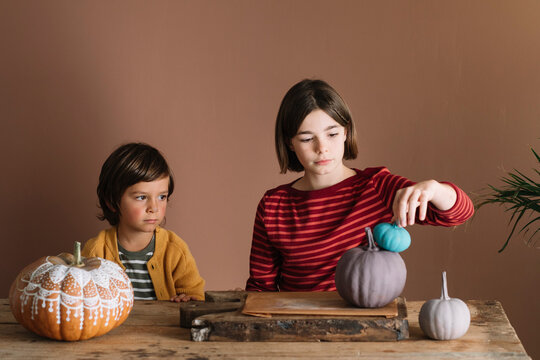 Kids playing with decorated pumpkins