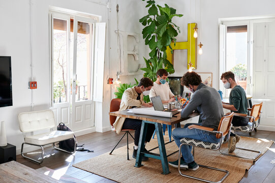 Designers working around an office table