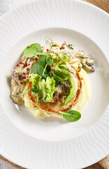 Mashed potatoes, mushrooms and rabbit cutlet. Restaurant food plate on white table. Delicious, healthy, organic dinner concept.