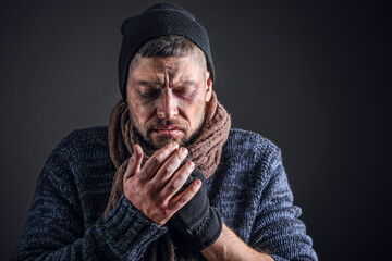 Portrait of poor homeless man on dark background