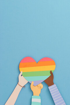 Many Hands Holding The Rainbow Heart Of LGBT Flag