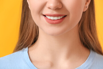 Beautiful smiling young woman on color background, closeup