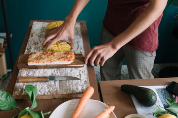 Young man arranging food for a creative magazine photo