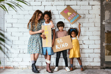 Multiethnic kids with inspirational posters