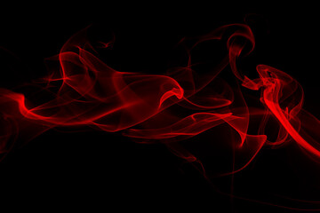 Fluffy puffs of red smoke and fog on black background