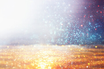 background of abstract gold, blue and silver glitter lights. defocused