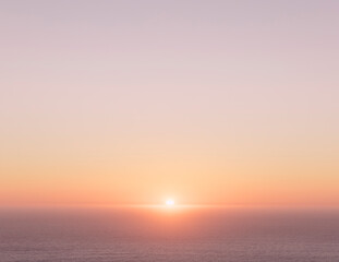 Setting sun over vast ocean