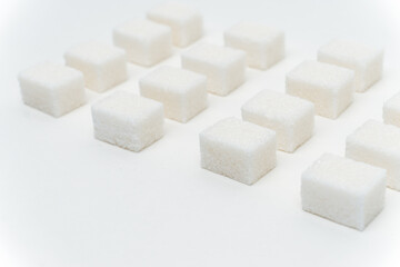 sugar cubes evenly spaced sweets ingredient light background