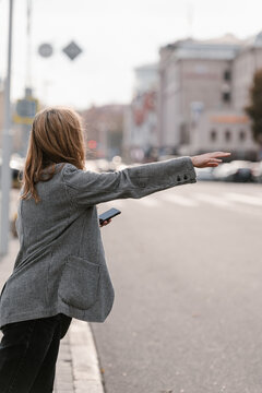 Woman catching taxi in city