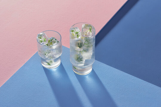 Glass of ice cubes with flowers
