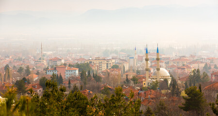 Modern landscape of Golhisar city with Muftis mosque in foggy winter morning