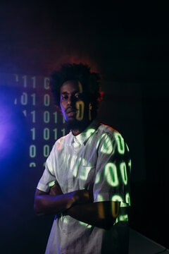 Black man in neon light in studio