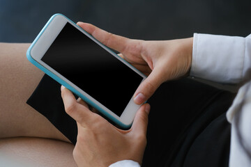 Close cup view female holding mobile phone with empty screen.