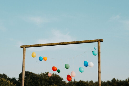 a row of balloons hanging outdoors