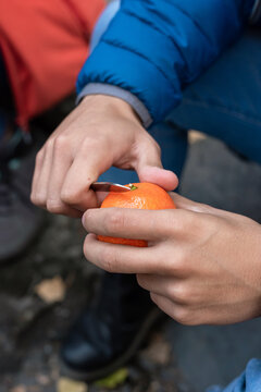 Young man Peeling A Mandarin