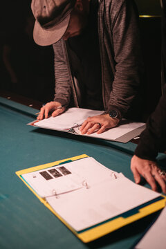 A film crew member reviews a script