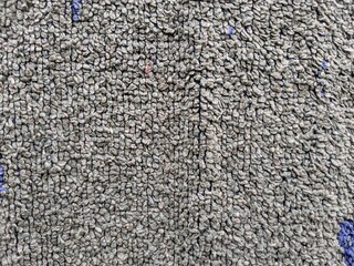 a gray cloth drying outside the house is photographed during the day