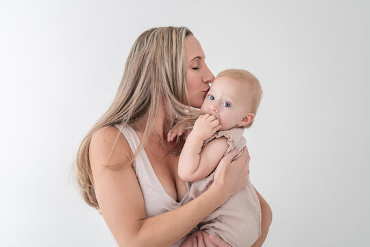 Mother kisses baby girl