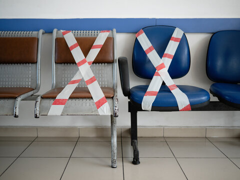 Chairs crossed with caution tape in times of pandemic