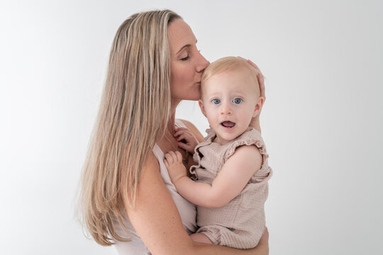 Mother kisses surprised daughter