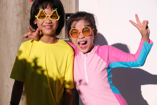 Beautiful and cute little Asian girls, wearing cute sunglasses. At the hostel