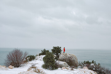 Woman looking at ocean in winter