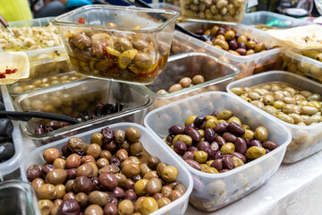 Assortment of Olives being sold at a traditional farmers street market
