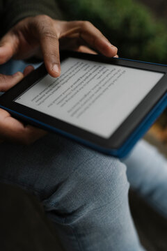 Black hands Holding an E-Book Tablet