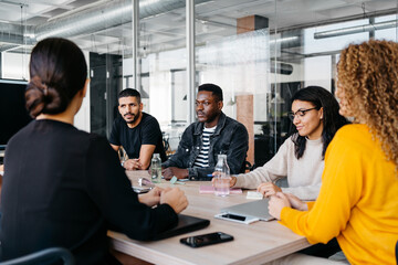 Crop diverse attentive businesspeople during a meeting in a modern work space