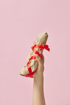 Erotic present sex toy phallus in a woman's hand.