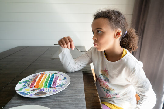 Girl tries bite of frosted layer cake