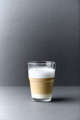 Coffee with milk on gray background. Close up. Copy space.	