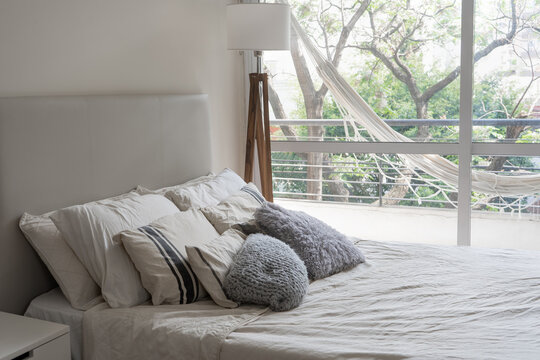 minimalist bedroom with pillows and hammock