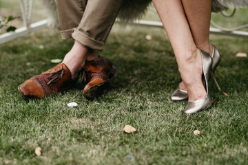 close up of man and womans feet on the grass