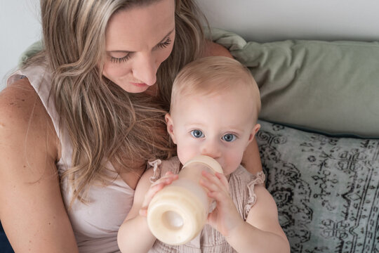 Girl looks and drinks her bottle