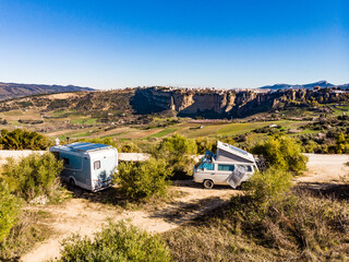 Caravans with solar panels on roof camping on nature. - obrazy, fototapety, plakaty
