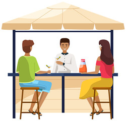 Drinking coffee and eating in street cafe. Friends meeting. Crowded outdoor restaurant or bar in city