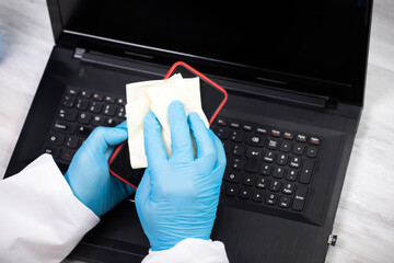 Disinfecting wipes to wipe surface of smartphone and desk at office. Stop the spread of coronavirus COVID-19.