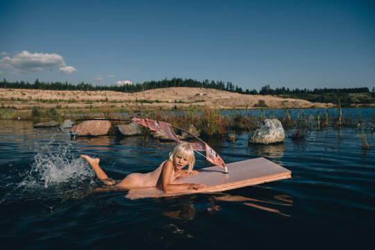 Child floating on the toy raft