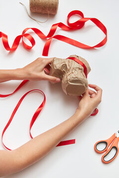 Woman's hands are making handcraft gift-wrapped.