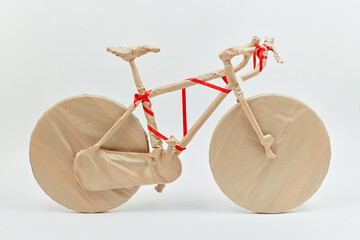 Creative gift on birthday bike wrapped of craft paper.