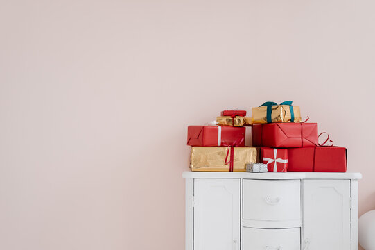 Stack Of Christmas Gifts On Cupboard