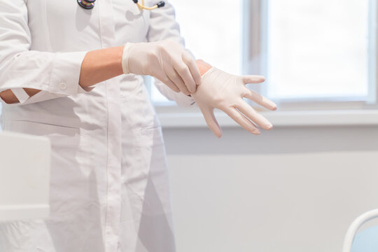 Anonymous Medical Worker Putting On Disposable Gloves