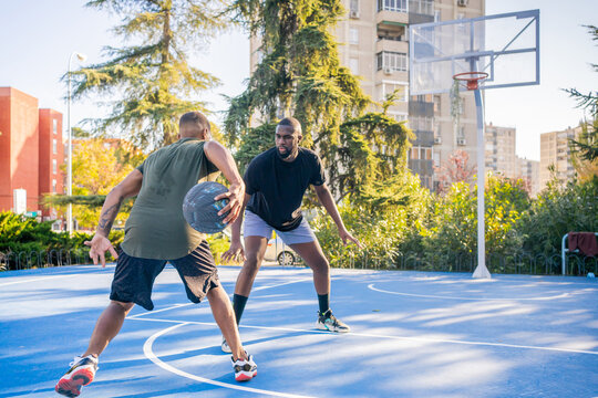 Two Friends Playing Basketball.