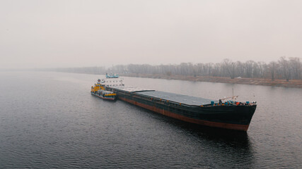 Top-view of two cargo ships like a child and it's parent