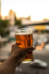 person holding a glass of cold beer