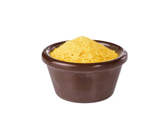 Nutritional yeast in brown bowl isolated on white background.