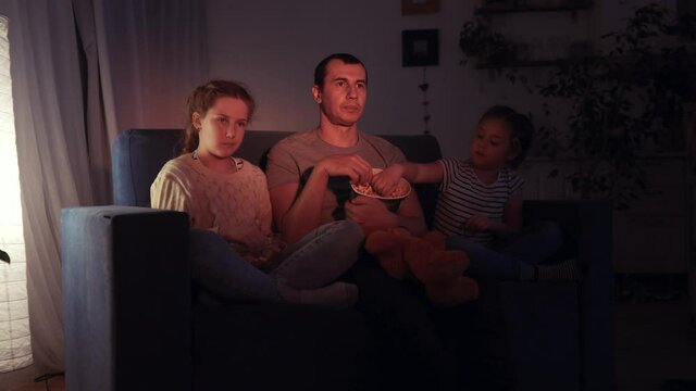 stay home. family - dad, daughter and small child are watching tv. coronavirus quarantine happy family together concept. happy family watching tv together. kid dream. people watching online movies