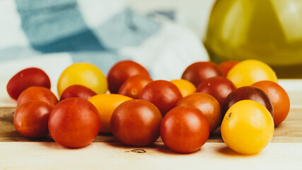 Closeup of various types of cherry tomatoes on a wooden table